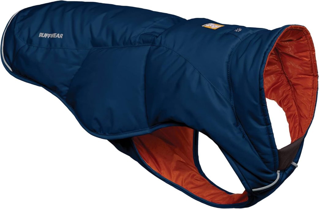 A navy blue dog coat with an orange lining and adjustable strap.